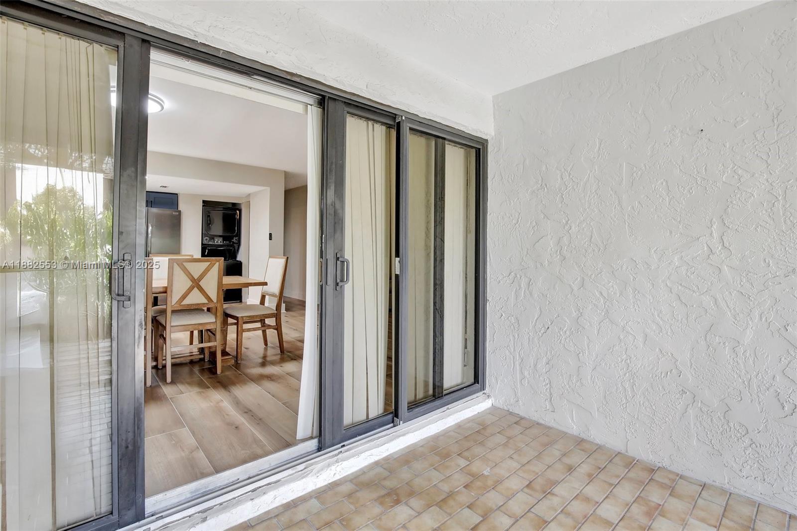 520 Orton Avenue, Unit 303 Fort Lauderdale, FL 33304 - Photo 17 of 20 a view of a livingroom with dining room and wooden floor