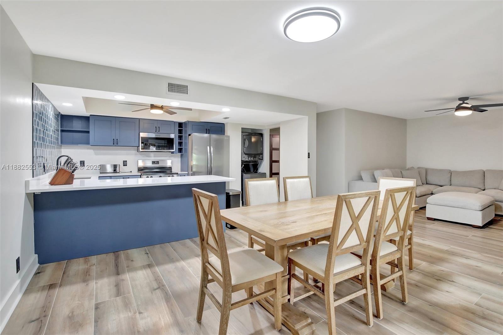 520 Orton Avenue, Unit 303 Fort Lauderdale, FL 33304 - Photo 5 of 20 a kitchen with a table and chairs in it