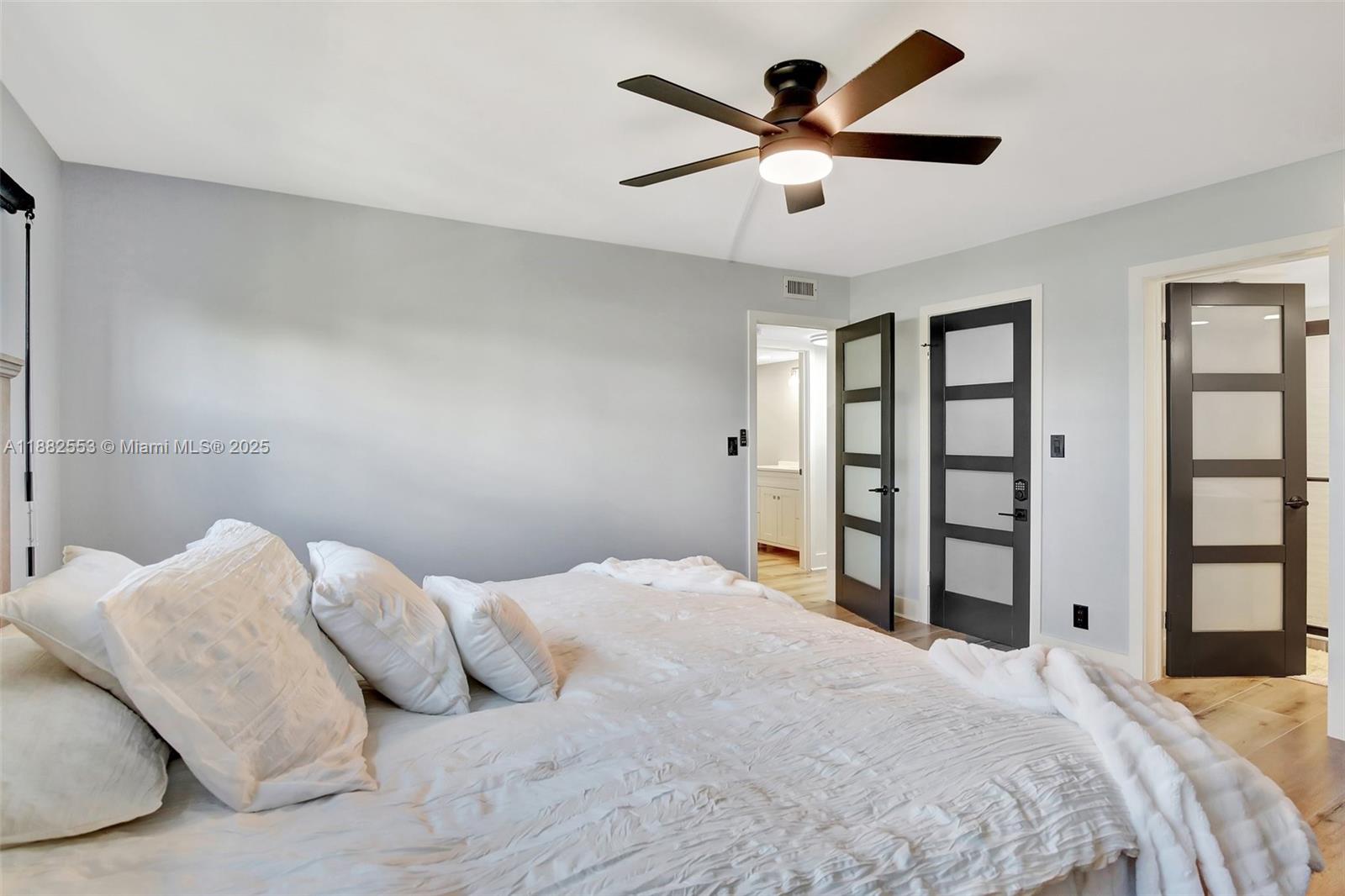 520 Orton Avenue, Unit 303 Fort Lauderdale, FL 33304 - Photo 9 of 20 a bedroom with a large bed and a chandelier