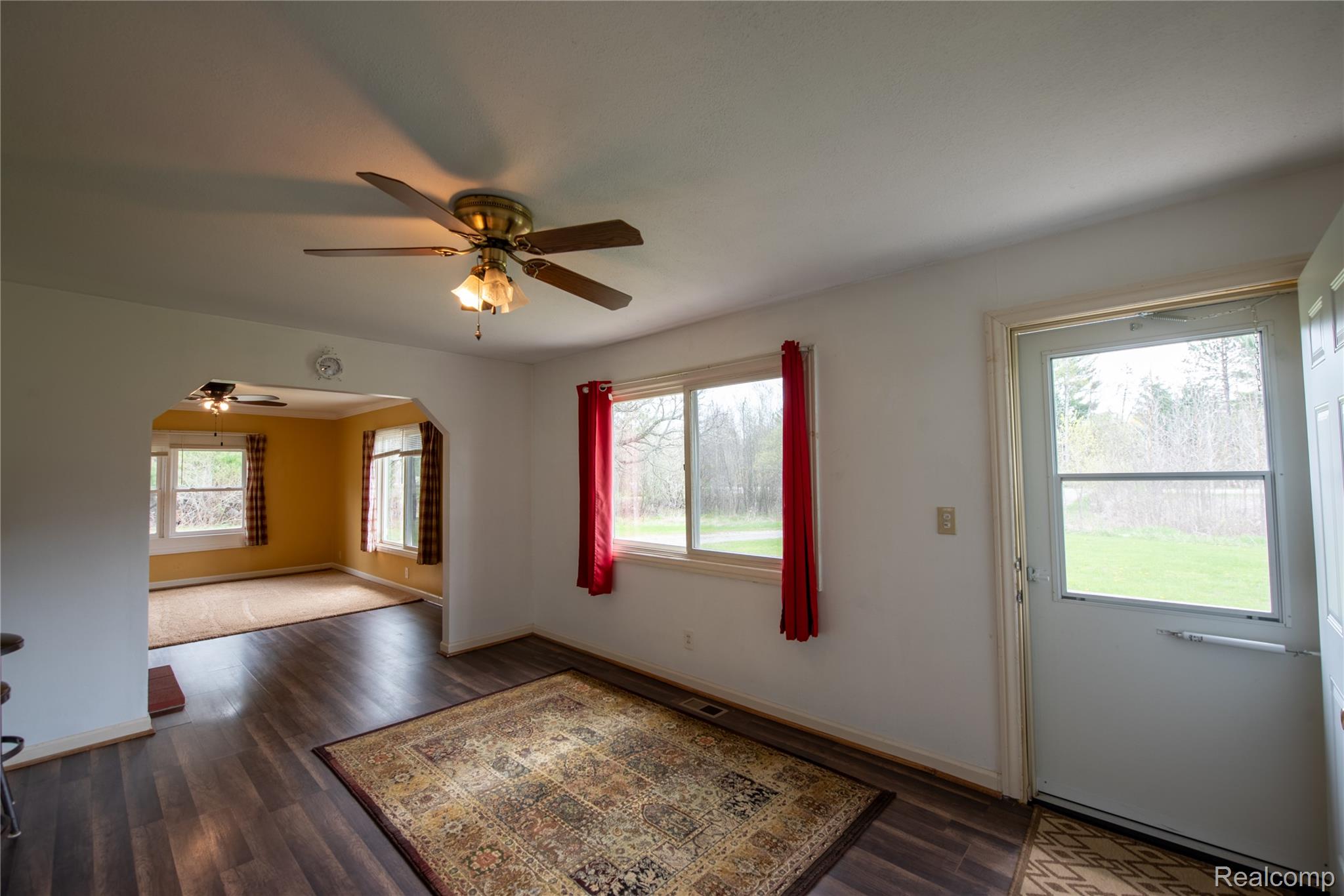 1190 Meadow Road Tawas City, MI 48763 - Photo 11 of 26 Entryway featuring wood finished floors, arched walkways, a ceiling fan, and plenty of natural light