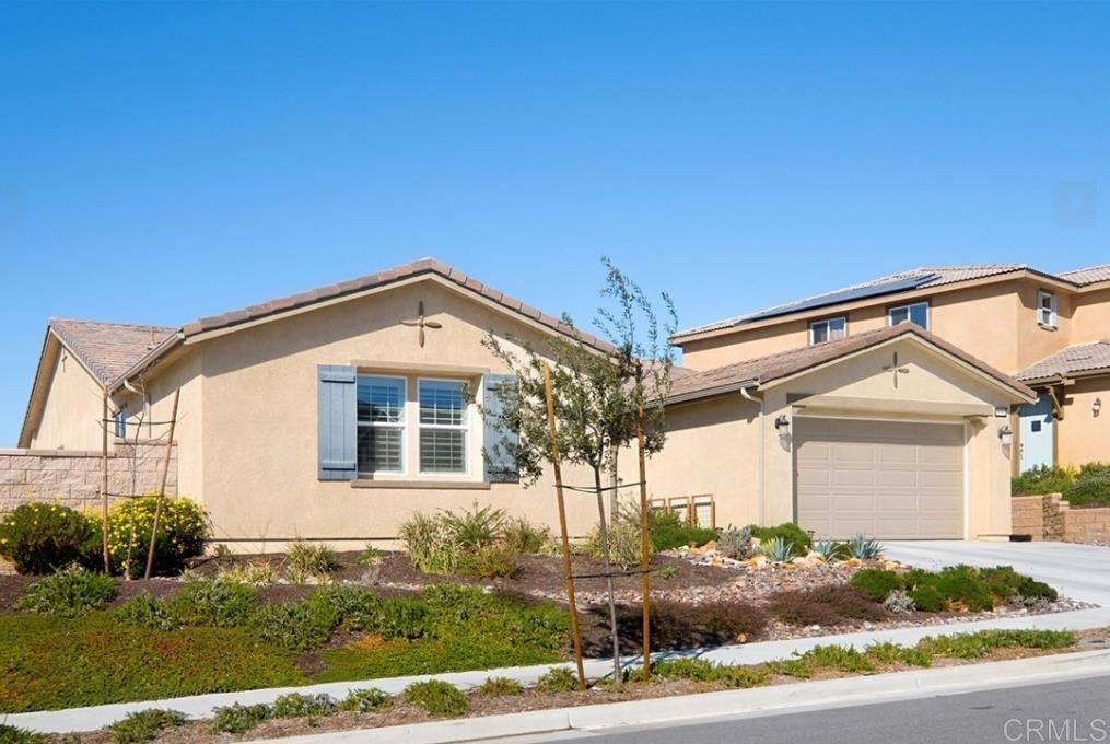33792 Baystone Street Temecula, CA 92592 - Photo 3 of 21 a front view of a house with a yard