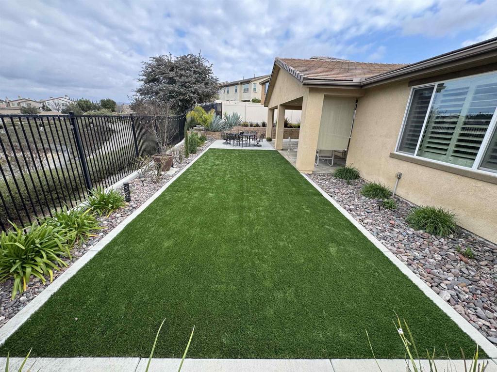 33792 Baystone Street Temecula, CA 92592 - Photo 8 of 21 a view of a house with a yard and lawn chairs