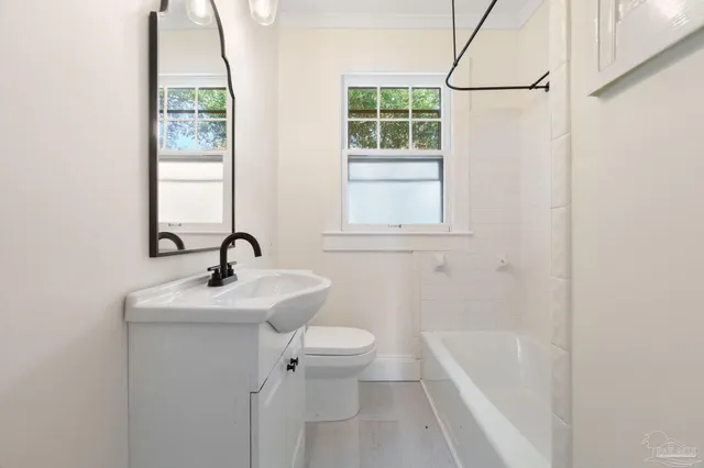 a bathroom with a sink a toilet and a bathtub