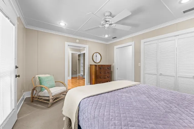 a spacious bedroom with a bed and a chandelier