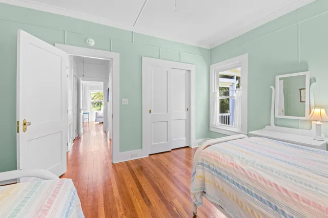 an aerial view of a house with outdoor space and trees all around