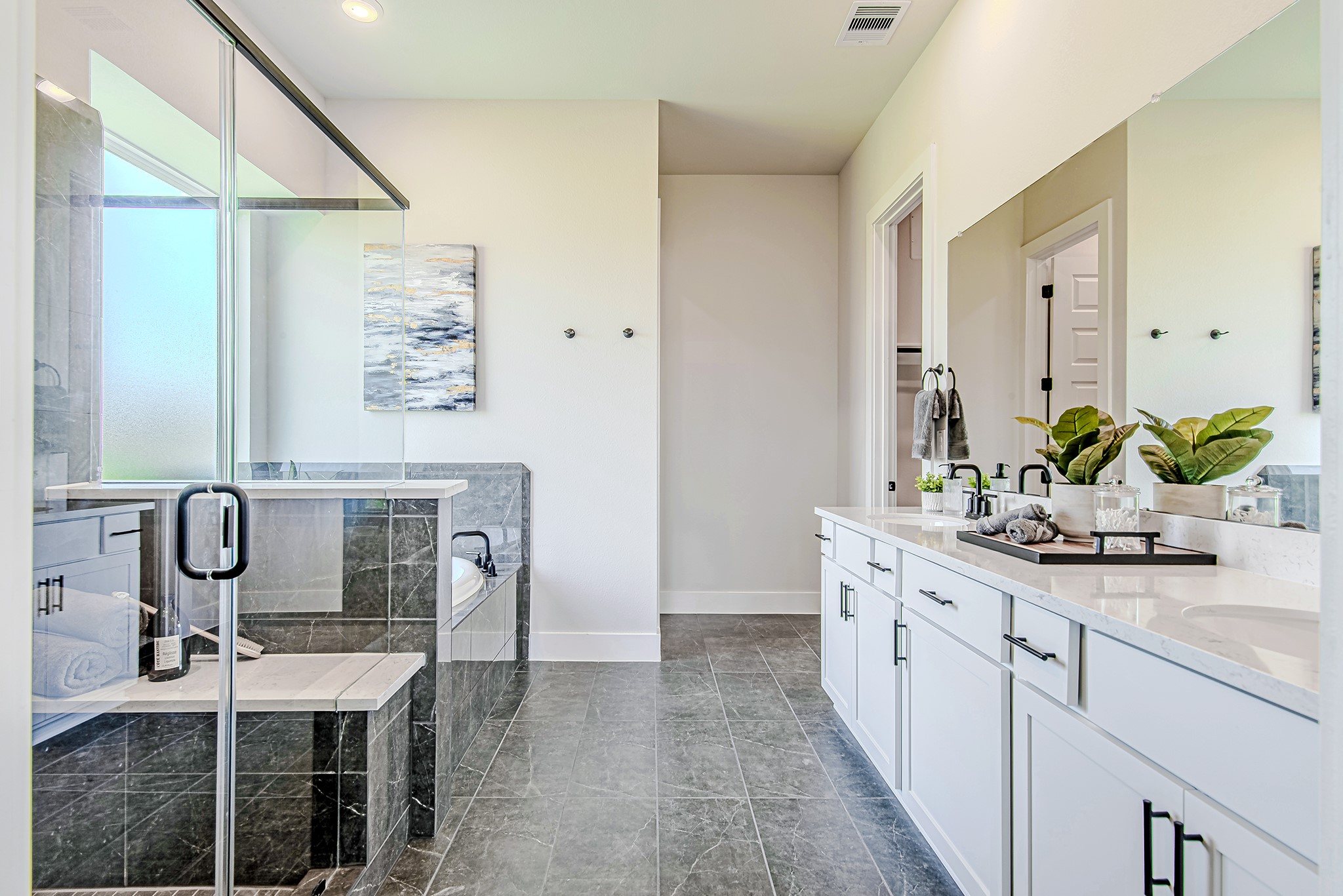 141 Peninsula Point Drive Montgomery, TX 77356 - Photo 4 of 47 The spa-like ensuite bath is complete with dual vanities, a soaking tub, and a sleek glass shower