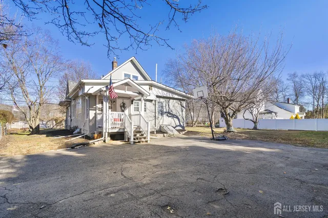 a view of a house with a yard covered in snow