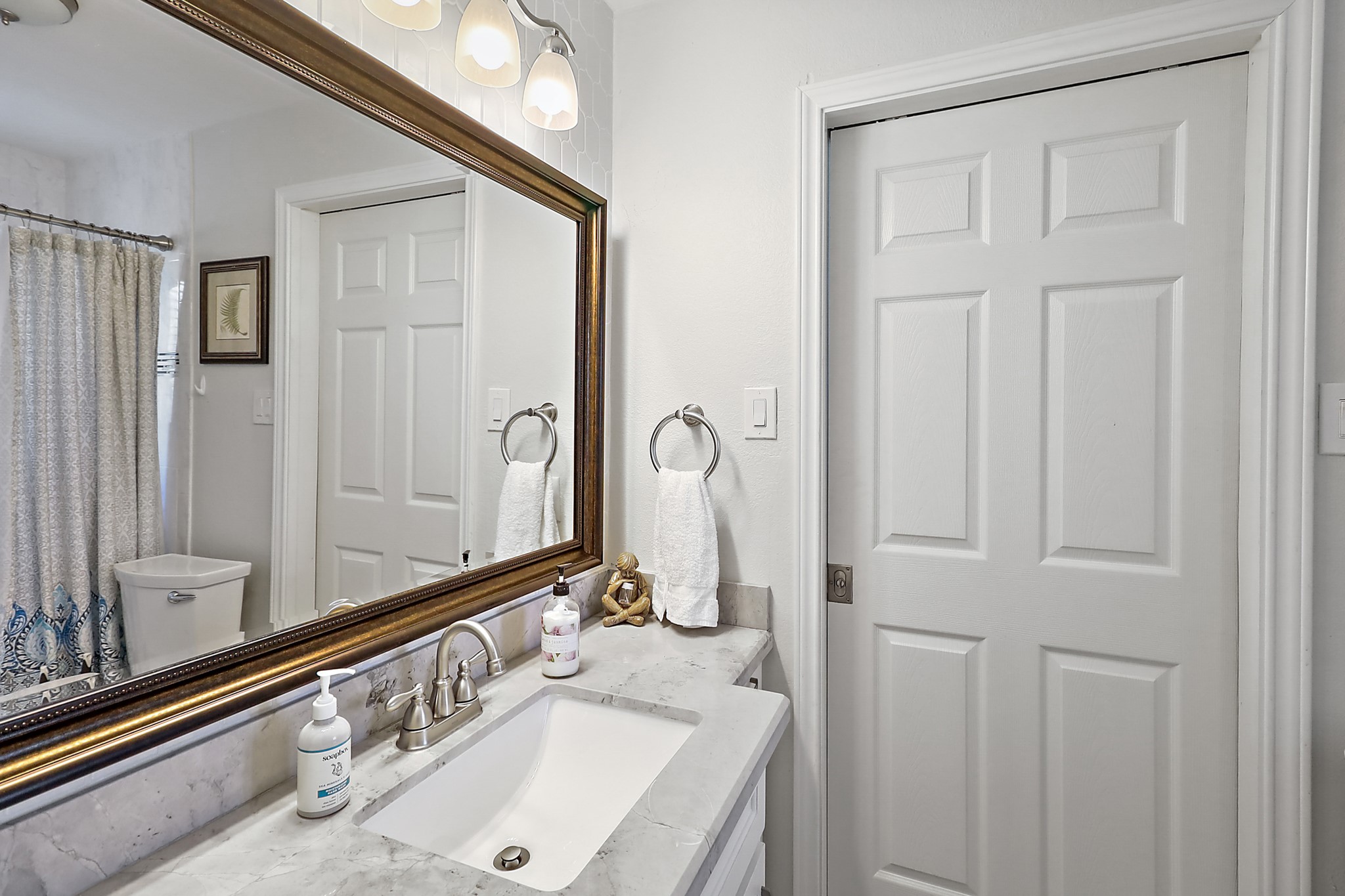 7317 Longview Street Houston, TX 77020 - Photo 17 of 30 a bathroom with a granite countertop sink and a mirror