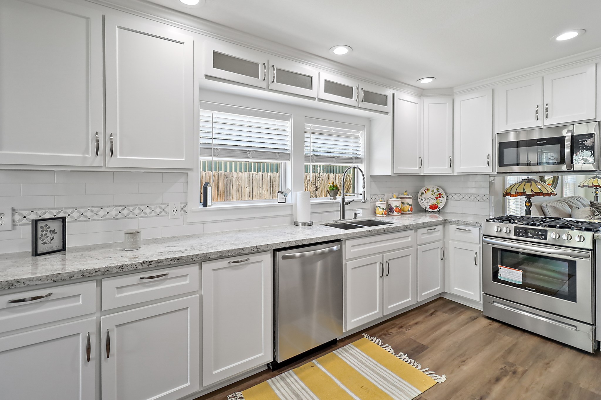 7317 Longview Street Houston, TX 77020 - Photo 9 of 30 a kitchen with granite countertop white cabinets and white appliances