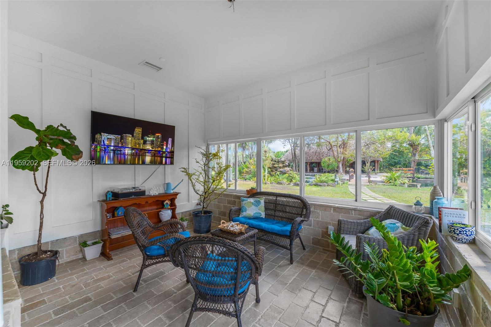 19820 Southwest 244th Street Homestead, FL 33031 - Photo 22 of 52 ENCLOSED PATIO W/ AC COULD BE A FAMILY ROOM WRAPPED WITH IMPACT WINDOWS OVERLOOKING THE GROUNDS