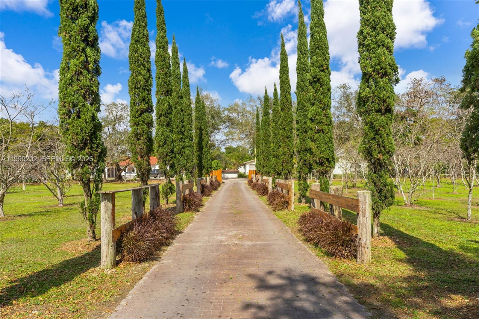19820 Southwest 244th Street Homestead, FL 33031 - Photo 52 of 52 IT. CYPRESS LINED DRIVEWAY