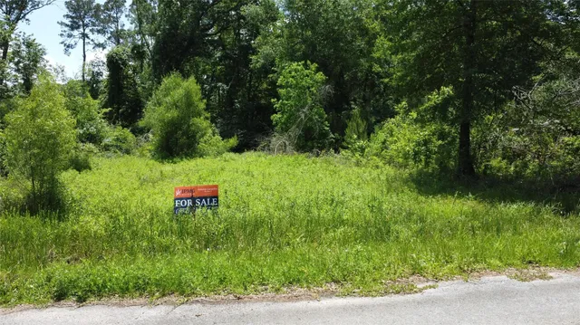 a backyard of a house with a table and chairs