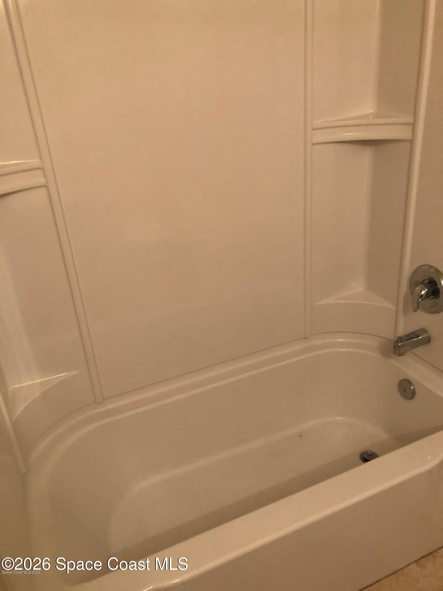 1280 Luminary Circle, Unit 103 Melbourne, FL 32901 - Photo 12 of 14 a bathroom with a bathtub