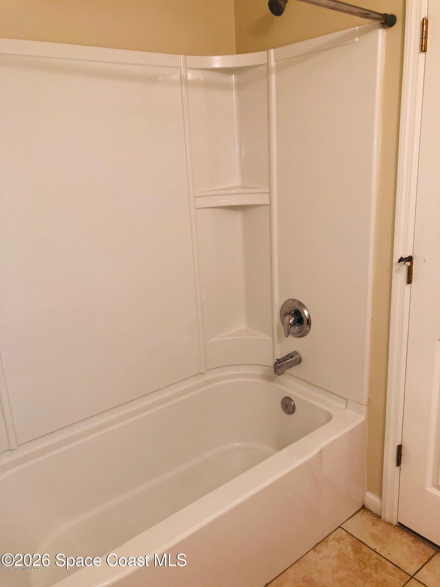 1280 Luminary Circle, Unit 103 Melbourne, FL 32901 - Photo 9 of 14 a bathroom with a bathtub