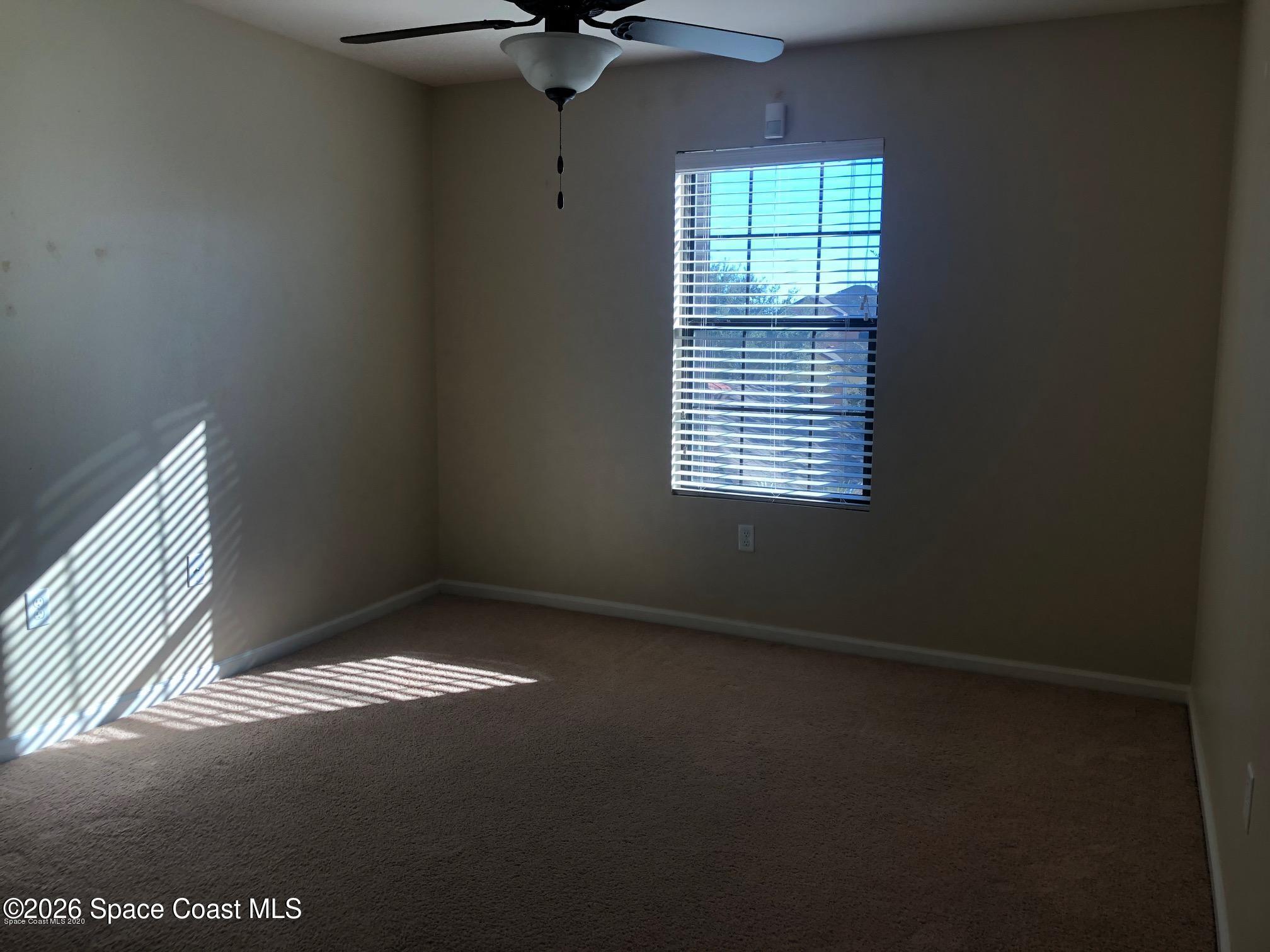 1280 Luminary Circle, Unit 103 Melbourne, FL 32901 - Photo 10 of 14 a view of an empty room and window