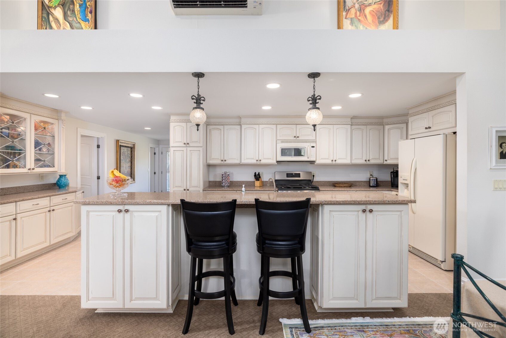733 Maple Avenue La Conner, WA 98257 - Photo 15 of 39 a kitchen with kitchen island granite countertop wooden cabinets and white appliances