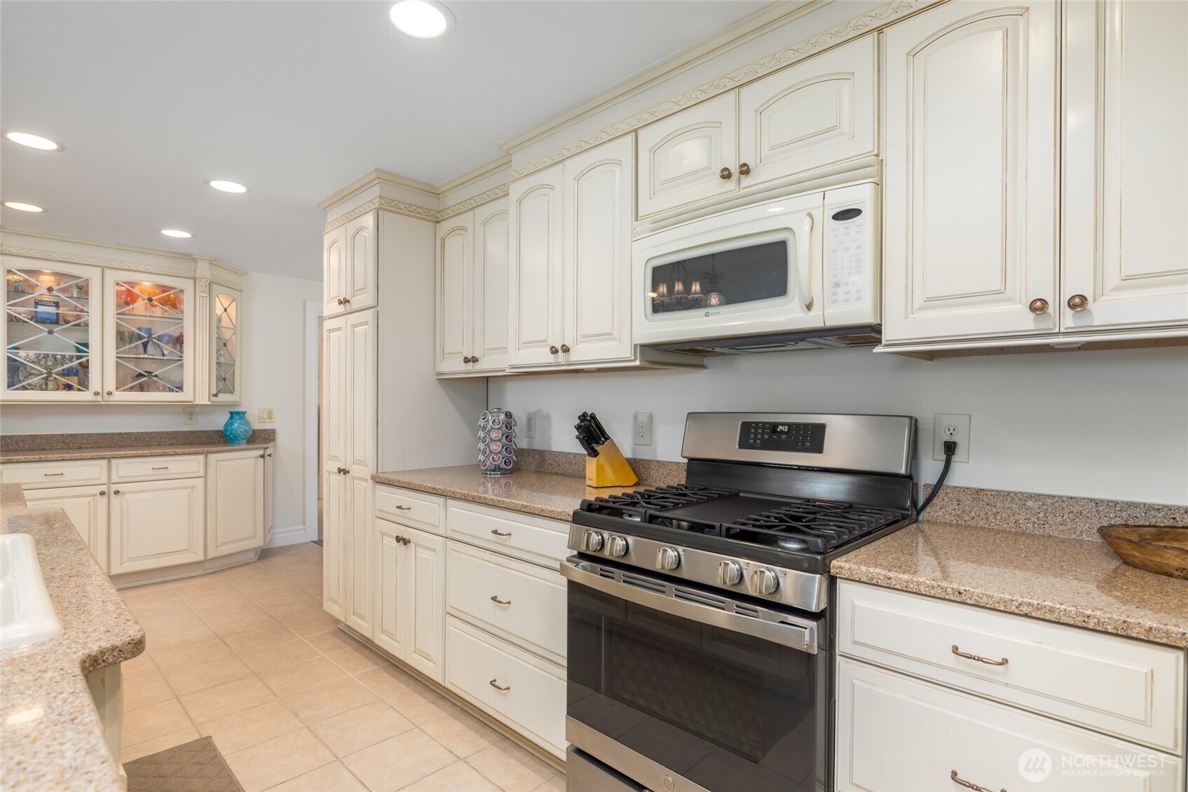 733 Maple Avenue La Conner, WA 98257 - Photo 17 of 39 a kitchen with granite countertop white cabinets and stainless steel appliances