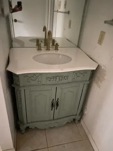 an empty room with a window and a ceiling fan