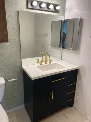 a view of a hallway with a ceiling fan and wooden floor