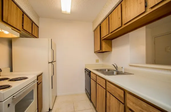 a view of a kitchen with a stove top oven