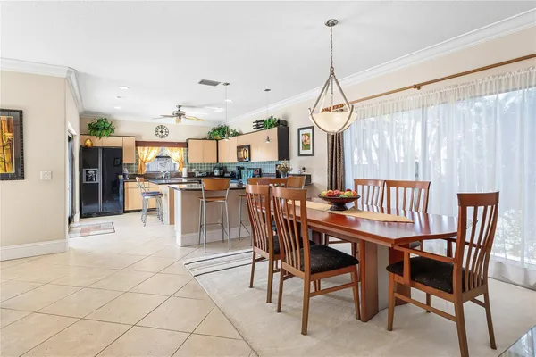 a dining room with furniture and wooden floor