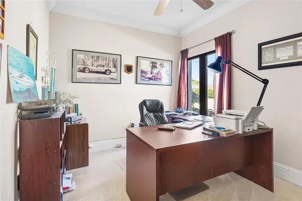 a work room with furniture and paintings on the wall