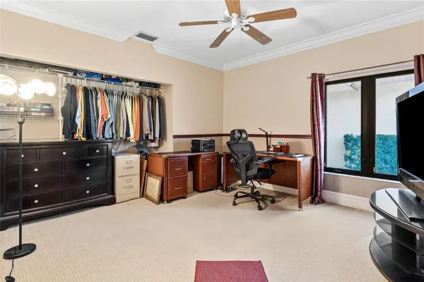 a view of a workspace with furniture and a window