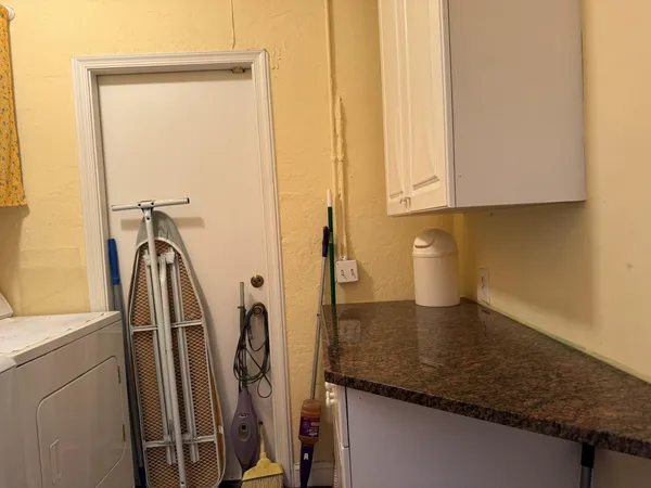 a view of a storage & utility room with a sink