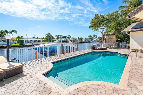 a view of a swimming pool with a lounge chairs