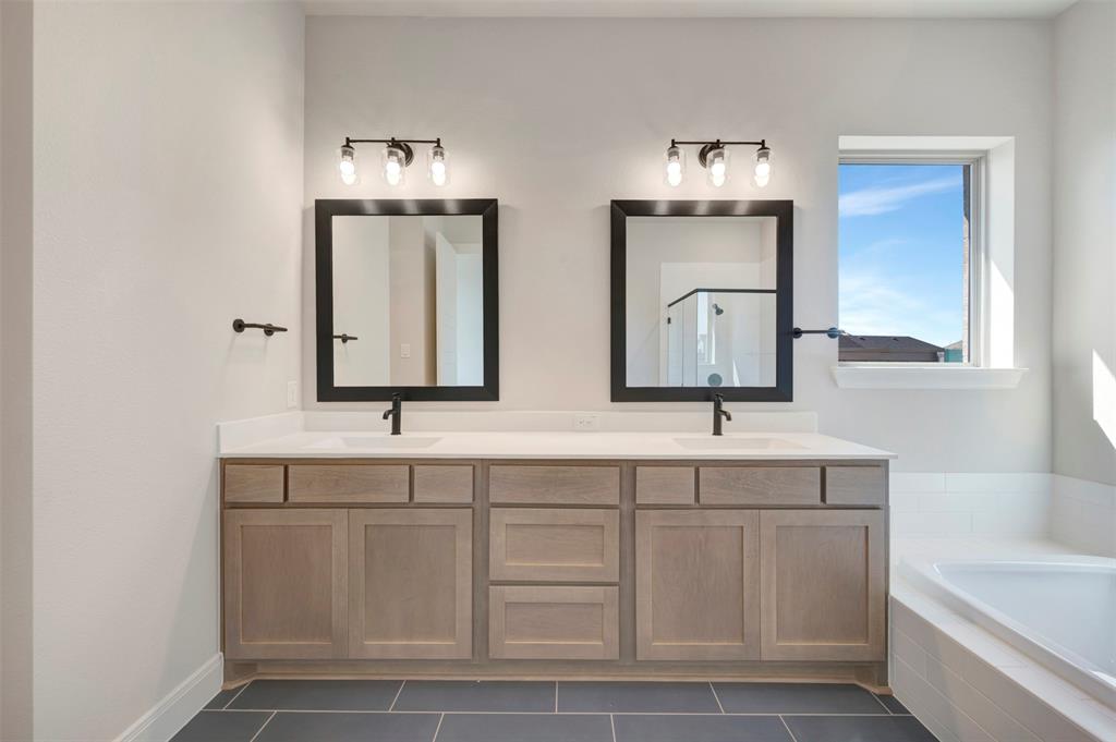 3575 Redbud Flower Trail Venus, TX 76084 - Photo 32 of 36 Bathroom featuring double vanity, dark tile patterned flooring, a bath, and a stall shower