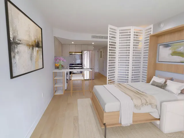 a bedroom with furniture and a large window