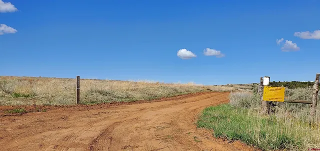 a white bench sitting next to a white wall