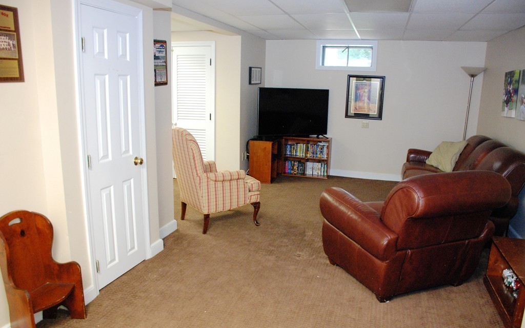 76 Stagecoach Road Duxbury, MA 02332 - Photo 19 of 26 a living room with furniture and a flat screen tv