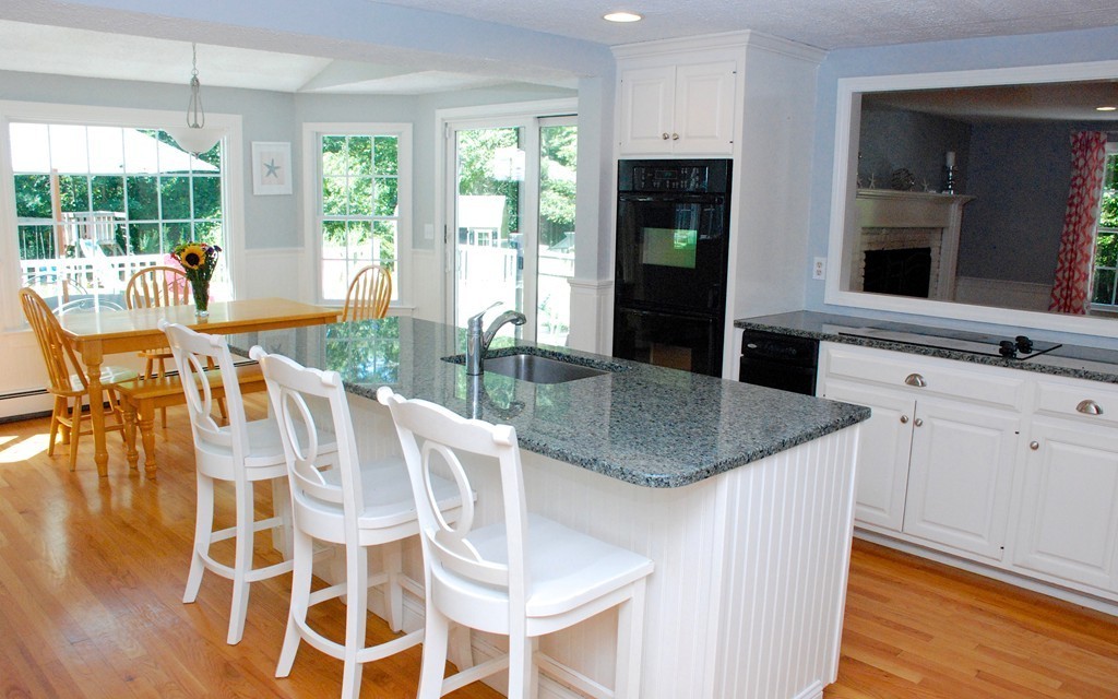 76 Stagecoach Road Duxbury, MA 02332 - Photo 3 of 26 a kitchen with granite countertop kitchen island a table and chairs in it
