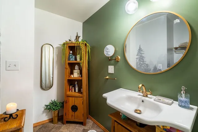 a room with stainless steel appliances a sink and a table