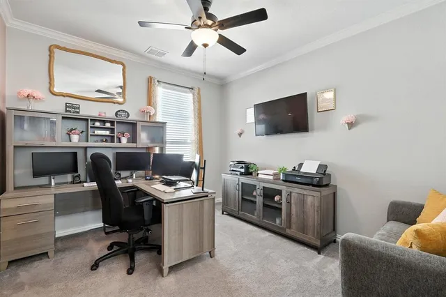a view of a workspace with furniture and a flat screen tv