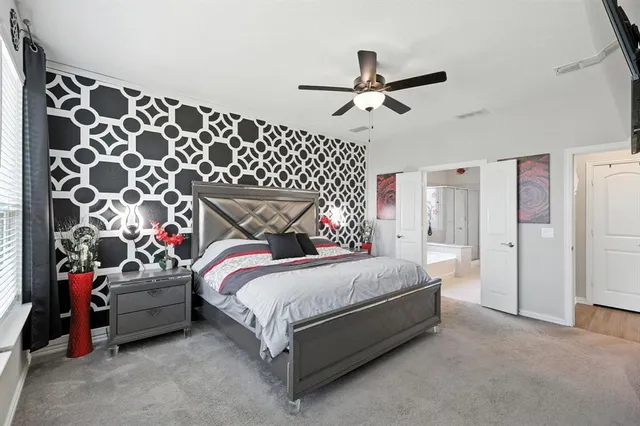 a bedroom with a bed and a mirror