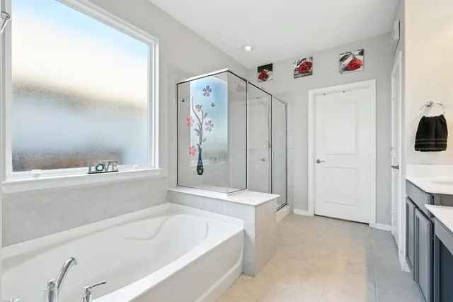a bathroom with a tub a sink and a refrigerator