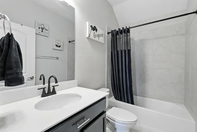 a bathroom with a sink toilet a mirror and shower