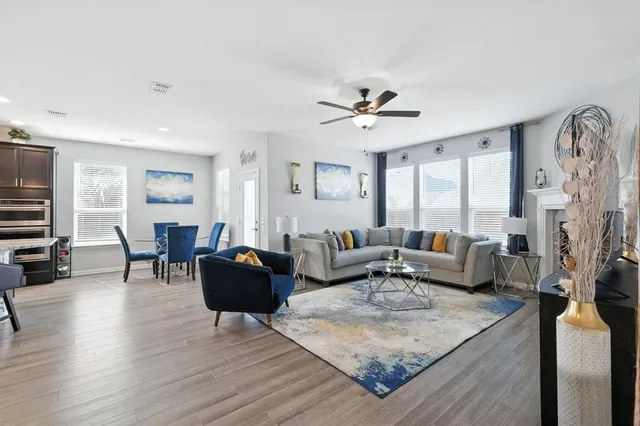 a living room with fireplace furniture and a flat screen tv