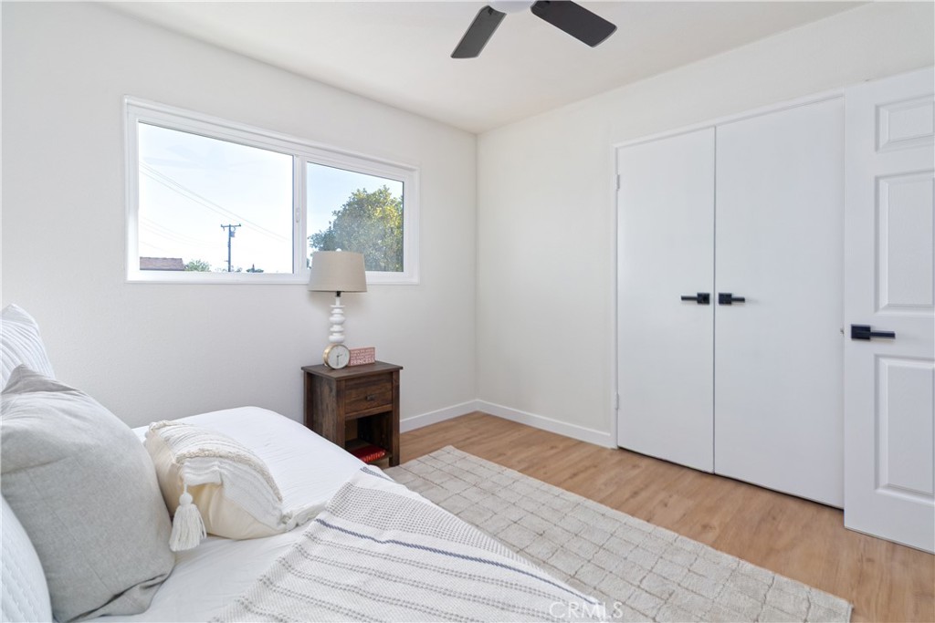 3306 Debbie Lane Riverside, CA 92501 - Photo 18 of 32 a bedroom with a bed and a chandelier