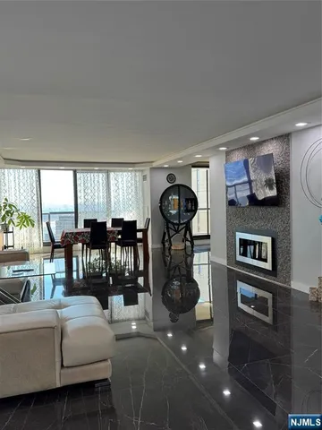 a living room with a bed furniture and a large window