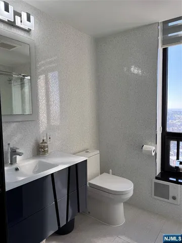 a kitchen with refrigerator and window