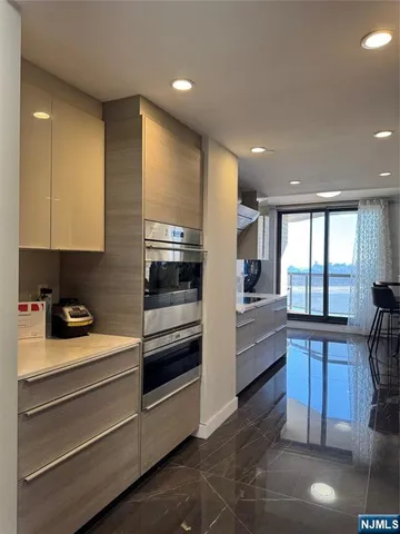 a living room with furniture and view of kitchen