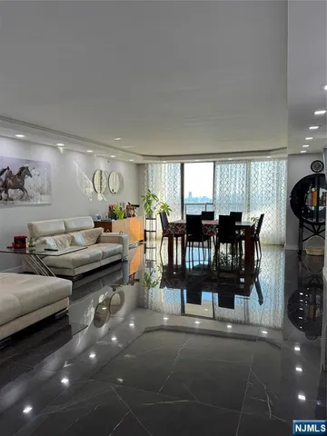 a bedroom with bed and a flat tv screen on dresser