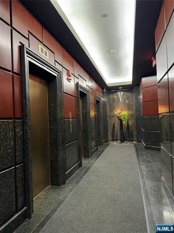 a view of a room with a potted plant and outdoor seating