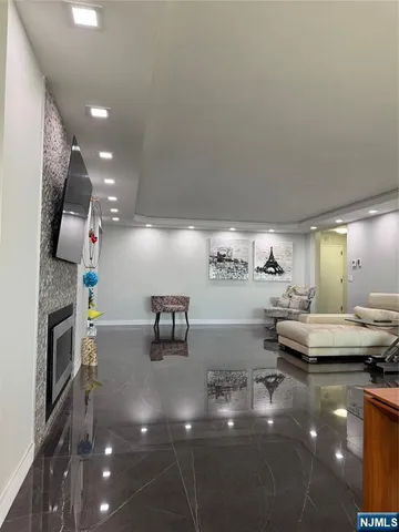 a open kitchen with stainless steel appliances a stove a sink and a refrigerator