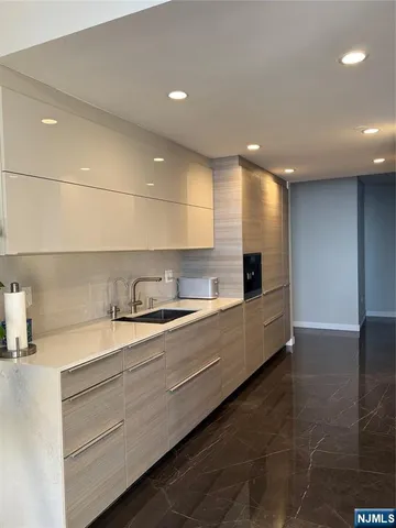 a kitchen view of cabinets and window