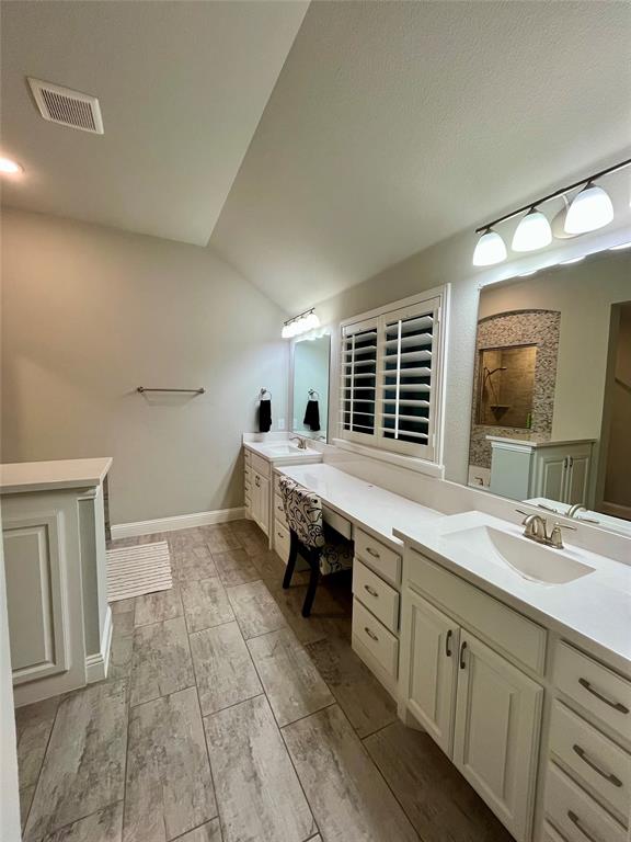 7040 Cross Point Lane Little Elm, TX 76227 - Photo 10 of 16 a spacious bathroom with a double vanity sink a mirror and a bathtub