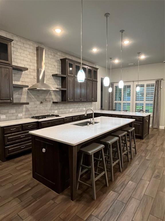 7040 Cross Point Lane Little Elm, TX 76227 - Photo 4 of 16 a kitchen with stainless steel appliances granite countertop a sink a stove and a wooden floors